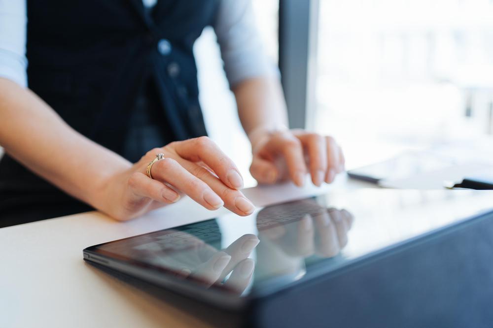 woman-fingers-typing-inscription-on-digital-tablet-3ZJFTJB