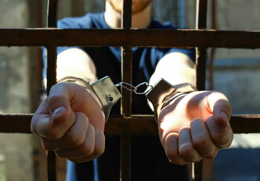 bigstock-Man-Handcuffed-In-Jail-Outdoor-330049744